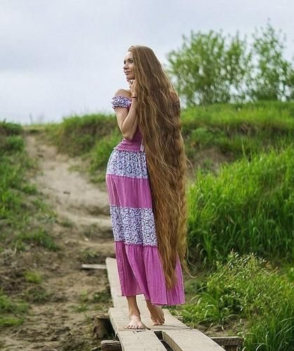 Beautiful girl with long hair hanging down to her toes